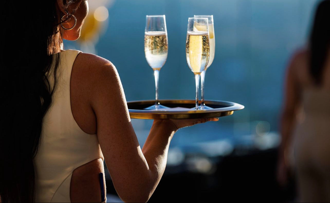 Custom casino cocktail server uniform designed for luxury hospitality and nightlife environments, combining a tailored fit with performance fabrics for comfort, movement, and brand consistency during high-volume service